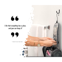 woman finding items in a toiletry bag that is hung on a hook 
